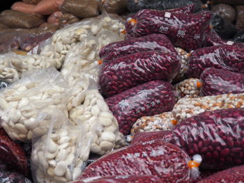 Various beans in plastic bags for sale at market