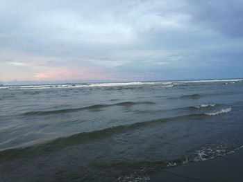 Scenic view of sea against cloudy sky