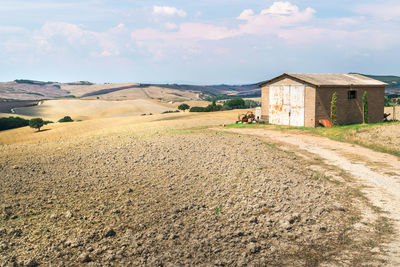 Houses on field against sky