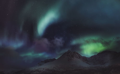 Scenic view of mountains against sky at night