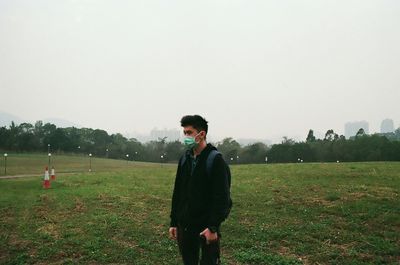 Man standing on grassy field