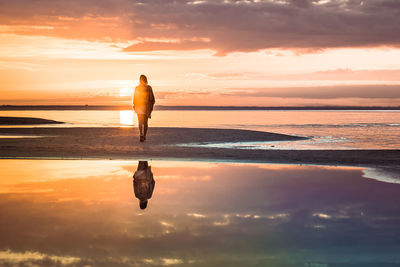 Full length of man on beach during sunset