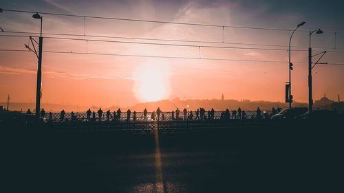 Silhouette city against sky during sunset