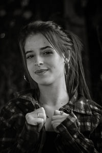 Portrait of smiling woman against trees