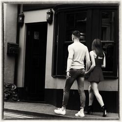 Full length of woman standing on railing