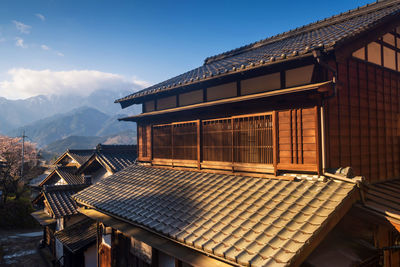 Roof of building and mountains against sky