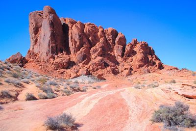 Rock formation at desert against clear blue sky