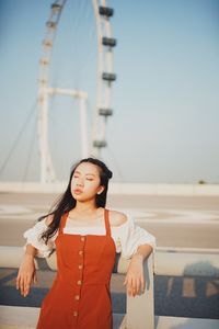 Thoughtful young woman standing on footpath