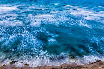 Aerial view of sea waves crashing on shore