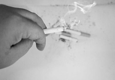 Close-up of hand holding cigarette