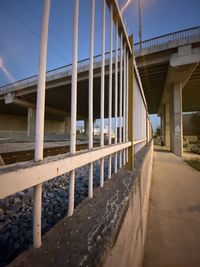 Bridge over road by building against sky