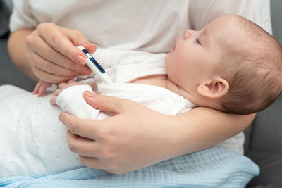 Close-up of doctor examining patient at home