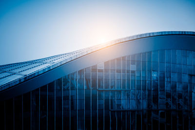 Low angle view of modern building against clear blue sky