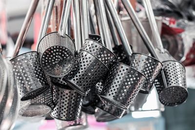 Close-up of kitchen utensils hanging for sale