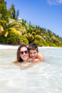 Portrait of young woman swimming in sea