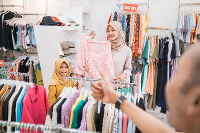 Happy family shopping in clothing store