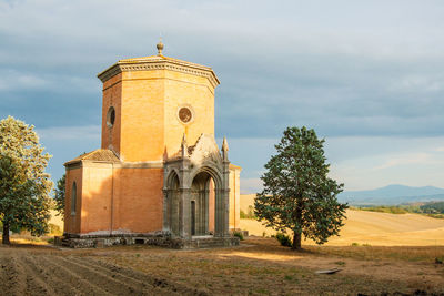 Church by building against sky