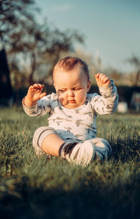 Cute baby girl on field