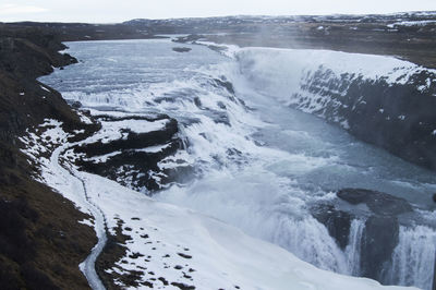 High angle view of sea and snowcapped mountains