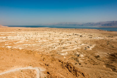 Scenic view of barren land near dead sea