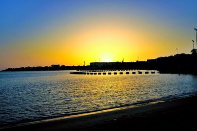 View of bridge over river at sunset