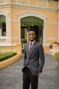 Portrait of businessman standing in city