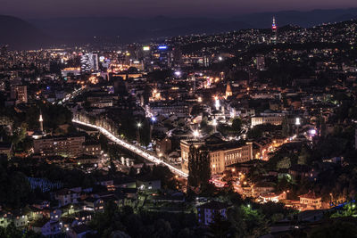 High angle view of illuminated city buildings at night