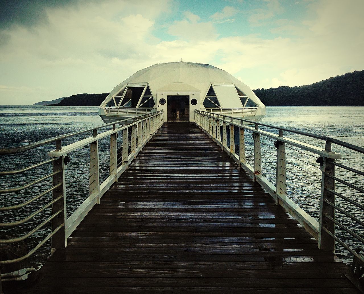 water, sea, railing, sky, built structure, mountain, pier, architecture, tranquil scene, tranquility, scenics, the way forward, nature, beauty in nature, cloud - sky, wood - material, jetty, leading, idyllic, mountain range