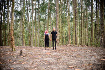 Man and woman standing in forest