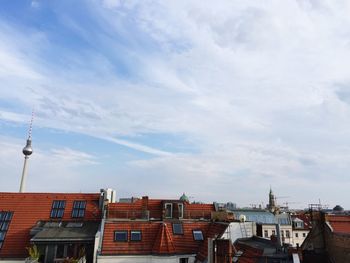 Low angle view of buildings against cloudy sky