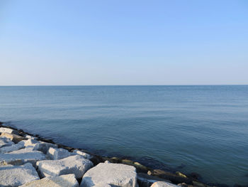 Scenic view of sea against clear sky on sunny day