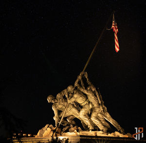 Low angle view of statue against sky at night