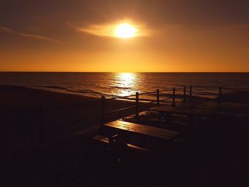 Scenic view of sea against orange sky