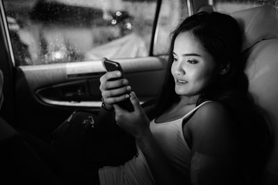 Portrait of woman sitting in car