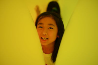 Portrait of smiling boy against yellow background