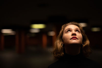 Close-up of thoughtful young woman looking up