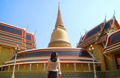 Female impressed by a pagoda and the circular gallery of wat ratchabophit temple, bangkok, thailand