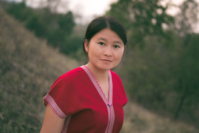 Portrait of young woman standing outdoors