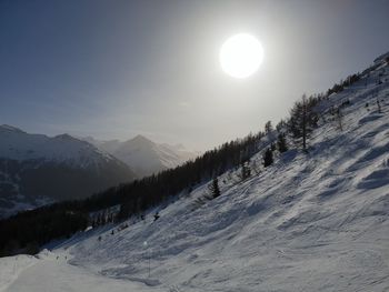 Scenic view of snow covered mountains against sky