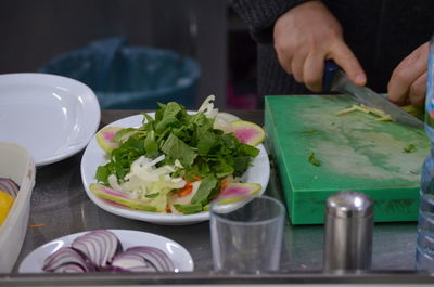 Close-up of person preparing food on table