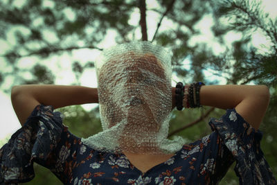 Close-up of woman holding bubble wrap on face