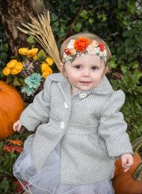 Cute baby girl with multi colored flower