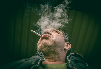 Close-up of man smoking cigarette