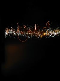 Close-up of illuminated christmas lights against black background