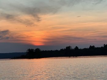 Scenic view of lake against romantic sky at sunset