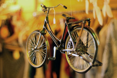 Close-up of toy bicycle hanging in shop