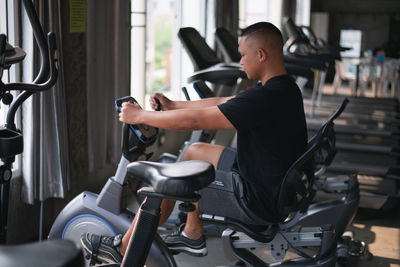 Side view of man exercising in gym