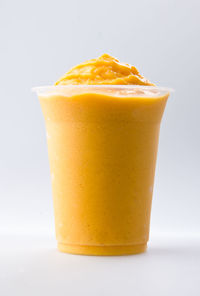 Close-up of orange juice against white background