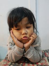 Portrait of cute girl sitting at home