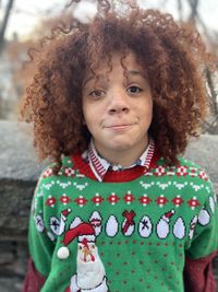 Portrait of a cute redhead boy with curly hair